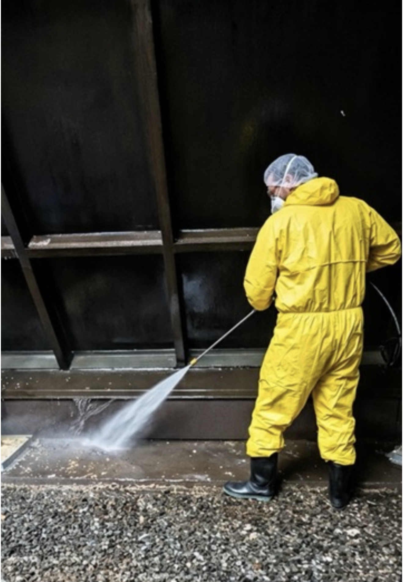 Yellow Wash technician wearing protective suit during specialty cleaning