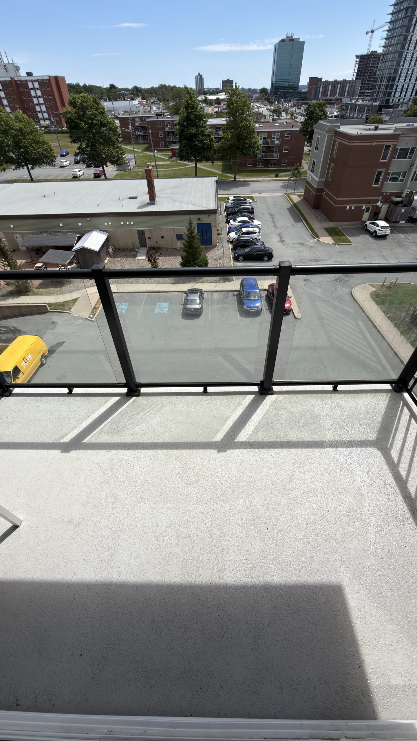 Clean concrete balcony with glass railings