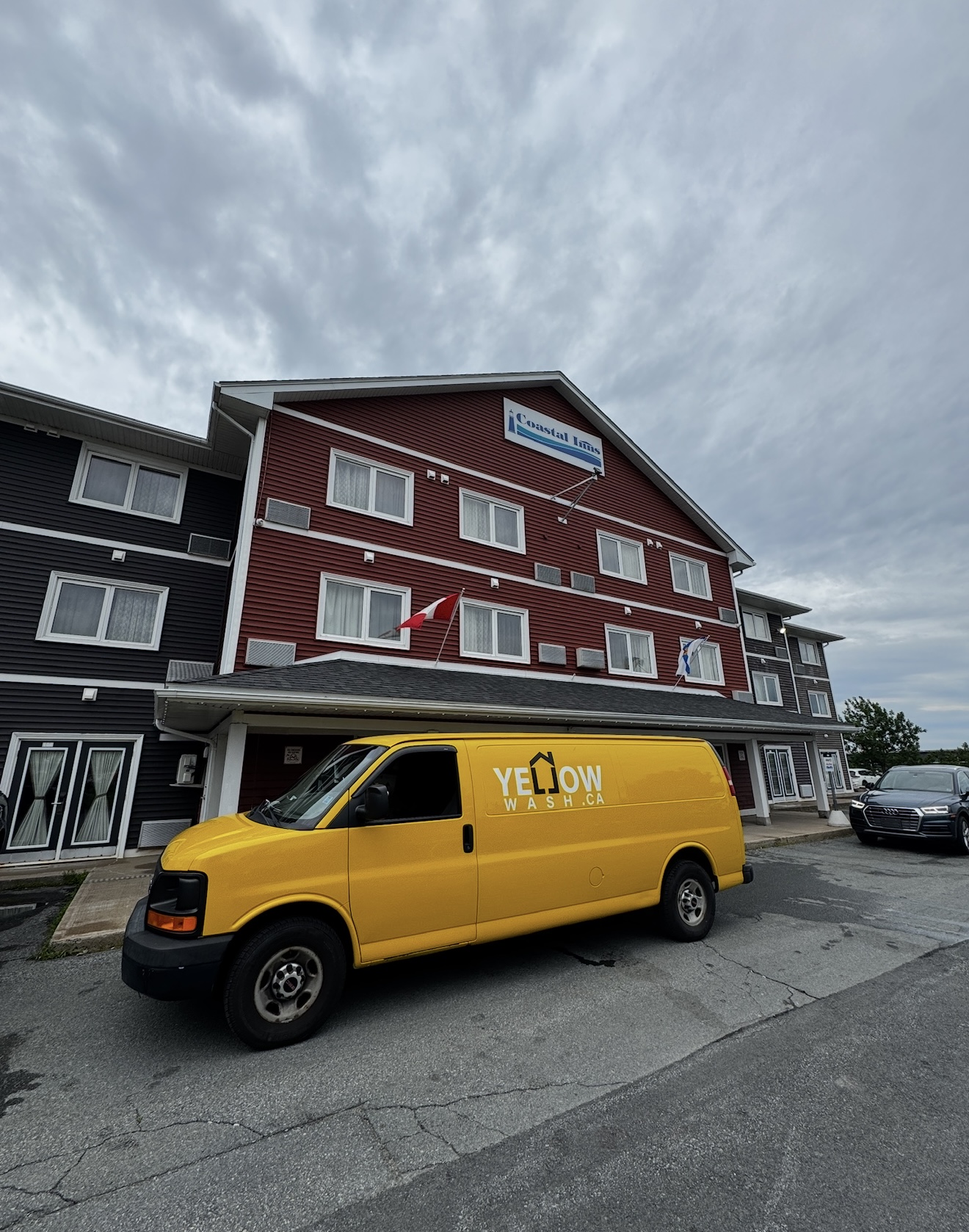 Yellow Wash van outside a Coastal Inns hotel